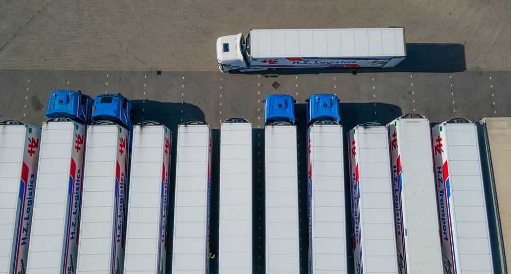 Semi-trailer trucks parked in a row